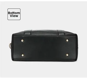 Detail view of the black pebble leather bag bottom with four gold protective metal feet