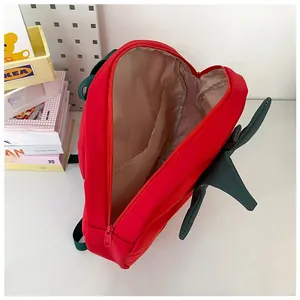 Detailed interior of the strawberry backpack showing the main compartment and inner pocket