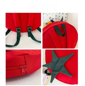 Detail view of red tomato backpack featuring wide straps and adjustable buckles
