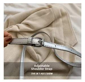 Detail of adjustable silver metallic shoulder strap with needle buckle on a bucket bag