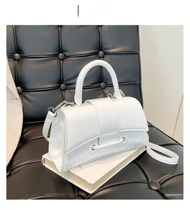 Detail of white hourglass handbag with glossy wrinkled texture and silver hardware