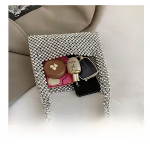 Silver beaded handbag interior view showing storage space for phone and makeup