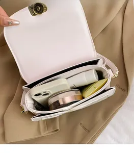 Interior view of small pink crossbody bag showing capacity for phone and cosmetics