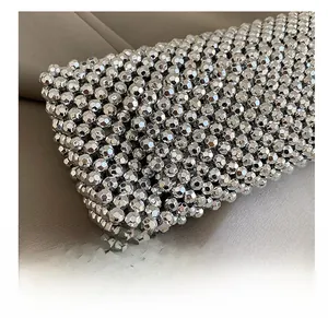 Macro view of silver hollowed-out metal beads and texture on a vintage shoulder bag