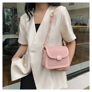 Detail of pink woven texture on women crossbody bag with adjustable PU leather strap