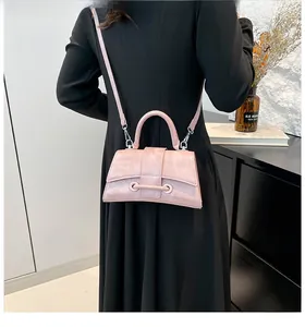 Detail of pink hourglass leather bag with elegant trapezoid shape and metallic strap buckle