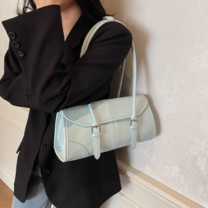 Minimalist light blue baguette shoulder bag with stylish straps and textured stitching
