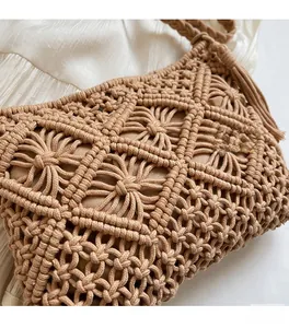 Close-up of brown hand-woven knit bucket bag showing intricate diamond mesh pattern and tassels