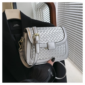 Close-up of silver woven texture cross-body bag featuring square buckle and fine craftsmanship