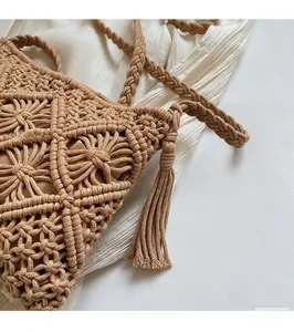 Detailed close-up of hollow knit texture and stylish fringe on a beige bucket bag