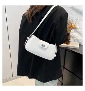 Detailed side view of white lychee pattern leather shoulder bag with silver lock