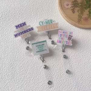 Detailed view of four acrylic retractable ID badge reels with colorful workplace themes