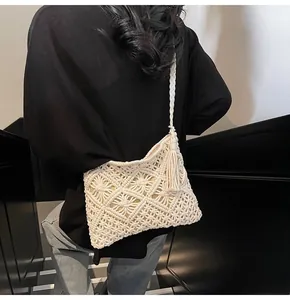 Detailed knit bucket bag featuring elegant macrame weave patterns and side tassels