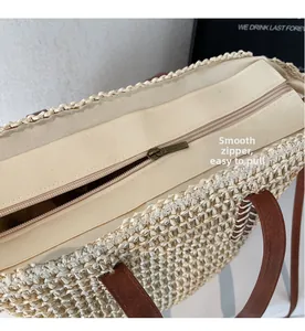 Close-up of smooth metal zipper and premium woven texture on the straw tote bag