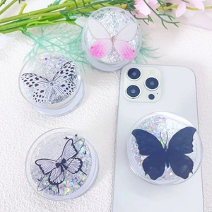 Detail of four butterfly phone grips with silver glitter sand and magnetic suction feature