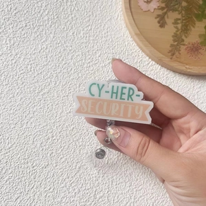 Handheld acrylic retractable badge reel with CY-HER SECURITY print and crocodile clip