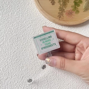 Detail of retractable badge reel with spreadsheet design and acrylic inspirational panel