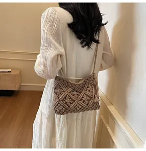 Detailed knit texture and tassels of a bohemian hollow-out crochet bucket bag