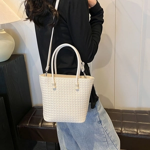 Minimalist beige woven tote bag for women with top handles and adjustable shoulder strap