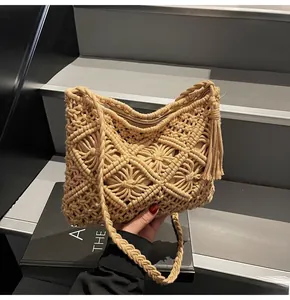 Close-up of beige macramé bucket bag featuring intricate woven geometric patterns and side tassels