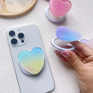 Gradient heart MagSafe phone grip with retractable stand on a modern smartphone