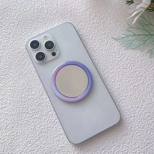 Close-up of portable purple gradient MagSafe mirror attached to a smartphone
