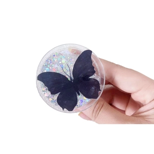 Sparkling butterfly magnetic phone grip with colorful sequins held in hand