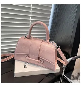 Detail of pink hourglass handbag featuring pleated PU texture and silver metal hardware