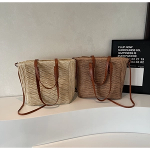 Close-up of woven straw tote bags with leather handles in beige and brown tones