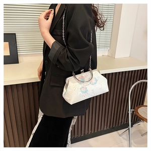 Fashionable floral embroidered crossbody bag shown on a model in a modern interior