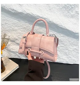 Detail of pink hourglass handbag with textured PU leather and elegant metal hardware