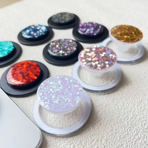 Glitter sequins magnetic phone socket stand in various vibrant colors on plush surface