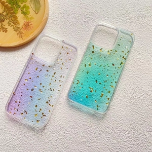 Detail showing gradient resin phone cases with gold foil accents and soft flocked interior