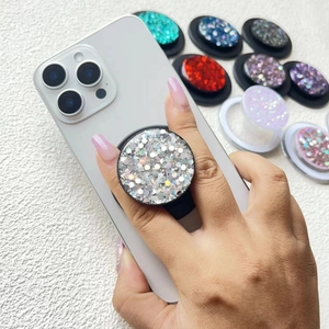 Glitter sequins magnetic phone socket stand in various colors shown on a white smartphone