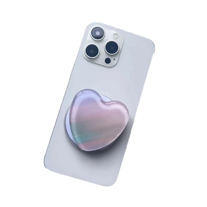Iridescent heart-shaped MagSafe phone grip with gradient resin finish on white phone