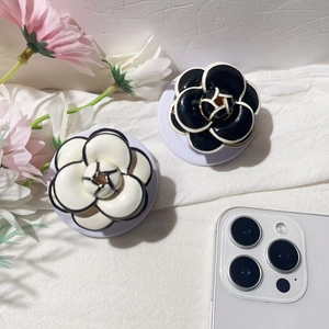 Detailed macro view of camellia shaped folding phone stands with glossy petal layers