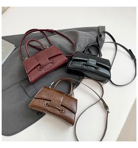 Detailed trio of hourglass handbags in burgundy, black, and brown oil wax texture