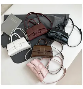 Detailed view of hourglass handbags in five colors with textured leather and top handles