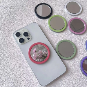 Portable MagSafe magnetic phone mirror stand with various pastel colors on a white phone