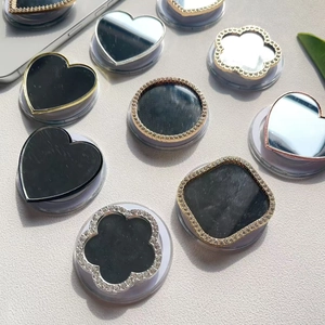 Close-up of rhinestone encrusted phone sockets with mirror surface and heart shapes