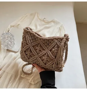 Close-up of bohemian knit bucket bag featuring hollow diamond weave and tassel details