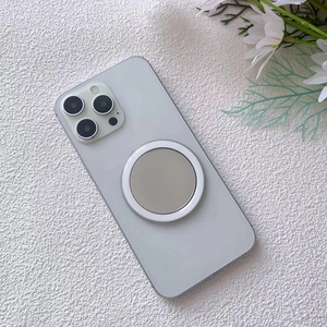 Macro view of portable MagSafe mirror accessory on phone with floral background
