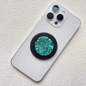 Macro detail of green glitter magnetic phone socket on a white smartphone back