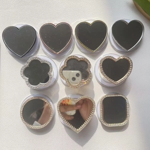 Close-up of various rhinestone square and heart-shaped folding phone grip mirrors