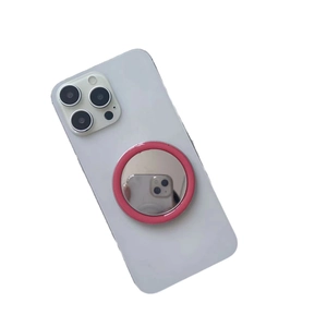 Portable pink MagSafe makeup mirror and phone stand accessory on a white smartphone