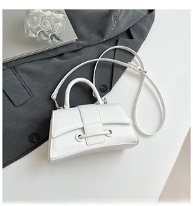 Detailed macro view of white hourglass handbag with textured crackle leather and handle