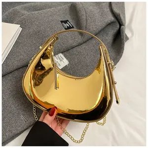 Detailed close-up of a gold mirror-finish mini hobo bag with a sleek round metal handle