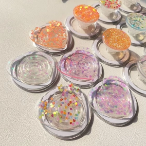 Macro detail of heart and round phone sockets with colorful iridescent glitter sequins