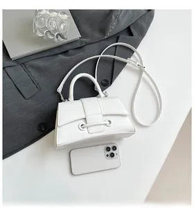 Detailed view of white hourglass handbag with textured PU leather and top handle