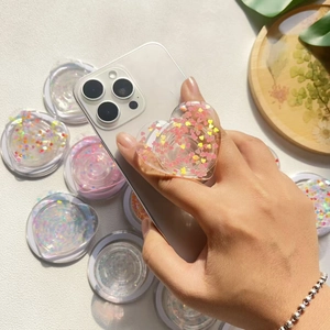 Glitter heart phone grip on iPhone with sparkling pink and yellow sequins